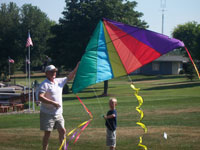 Toronto back pain free grandpa and grandson playing with a kite